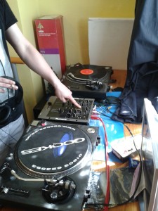 DJ Jimmy testing out the repaired Technics 1210 record deck